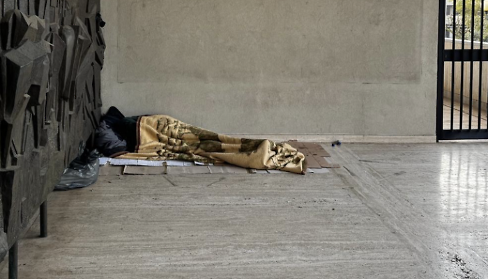 The homeless man sleeping in front of the Provincial building is a symbol of failure.